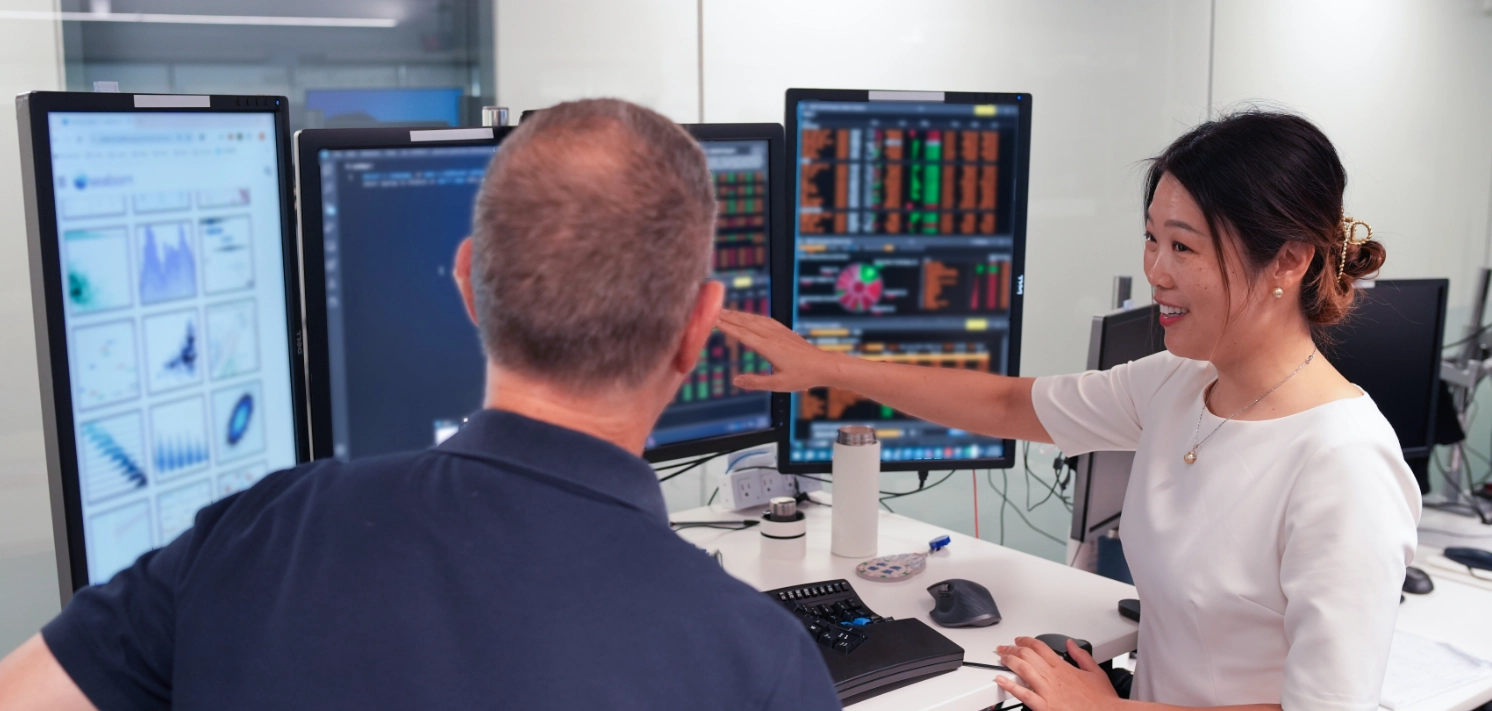 Two employees at trading desk